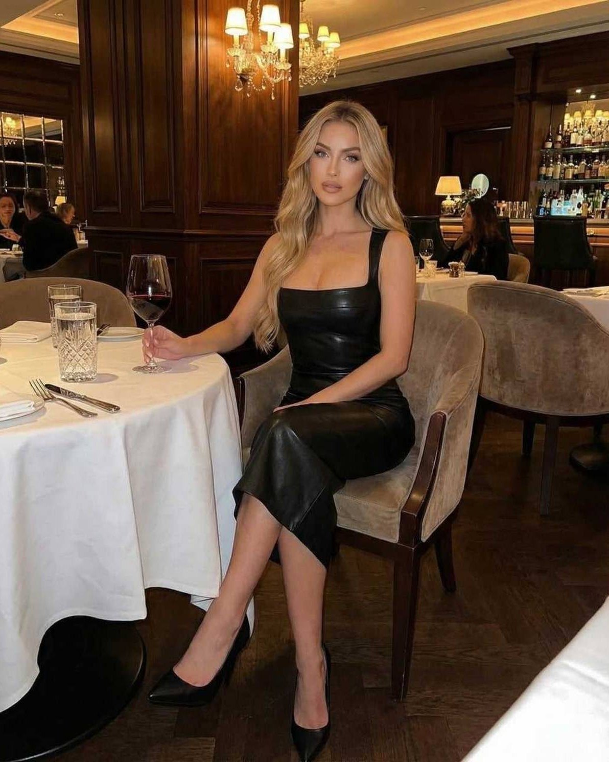Orion Midi Dress by Lauven, featuring sleek leather elegance, worn at an upscale venue, ideal for sophisticated events.