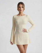 Orion Mini Dress - Elegant long sleeve cable knit mini dress by Lauven, featuring a soft cream tone and a cozy silhouette.