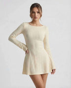 Orion Mini Dress by Lauven, elegant cable knit, soft cream tone, long flared sleeves, cozy and sophisticated look.