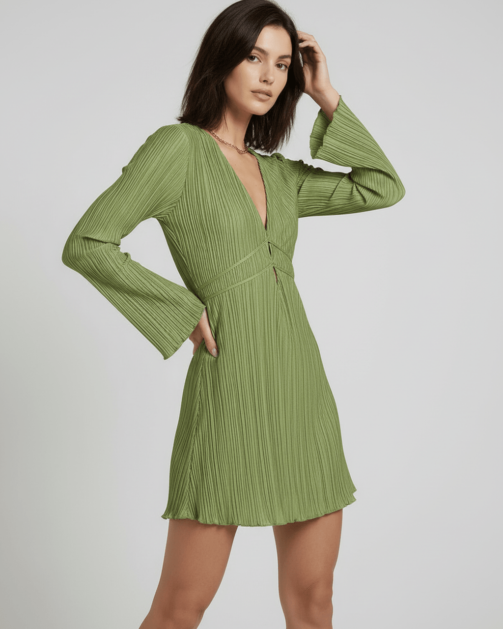 Orion Mini Dress by Lauven, elegant olive green pleated mini dress with long sleeves and a deep V-neckline.