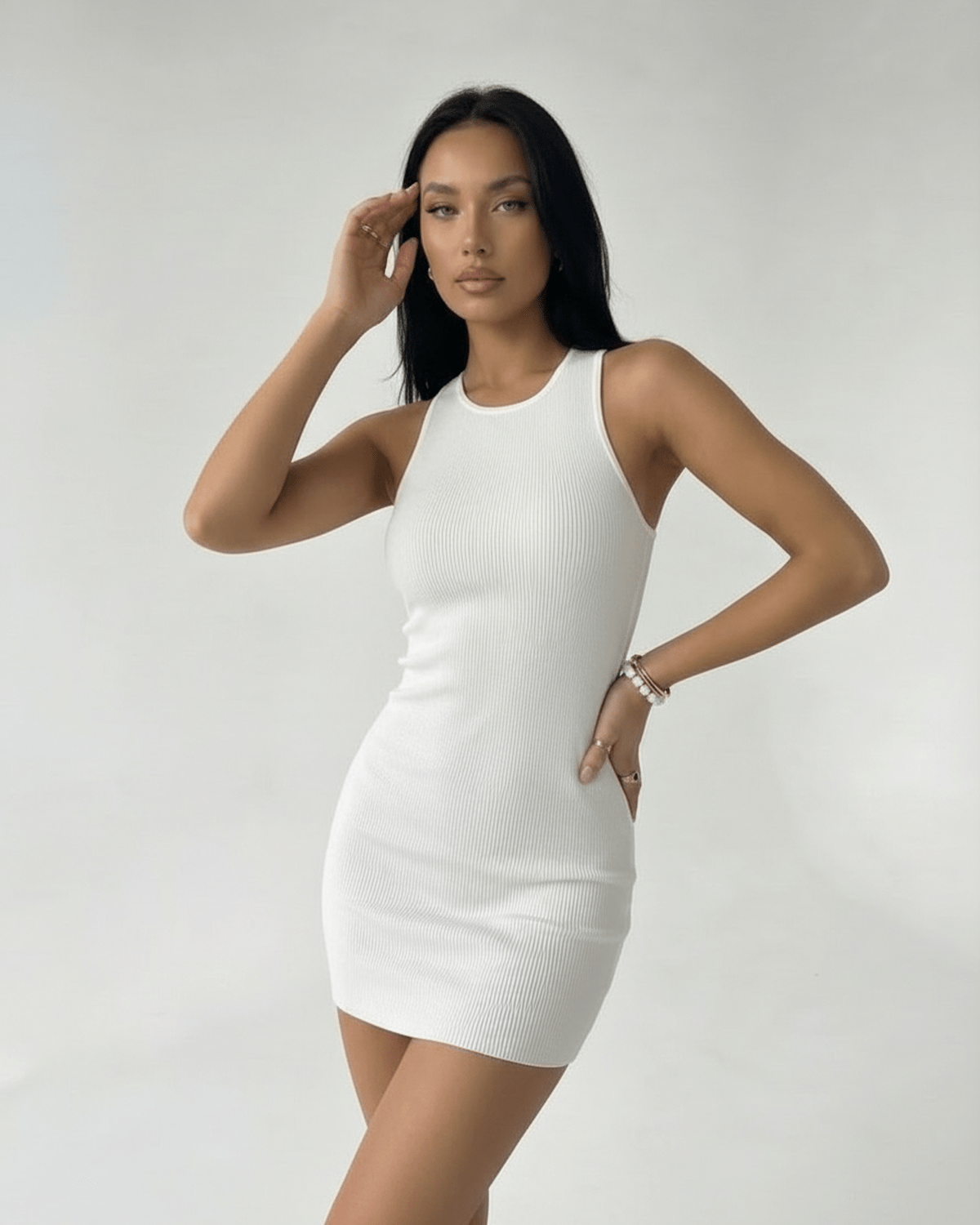 Orion Mini Dress by Lauven – Ribbed knit white mini dress with cross back detail, offering a sleek fit.
