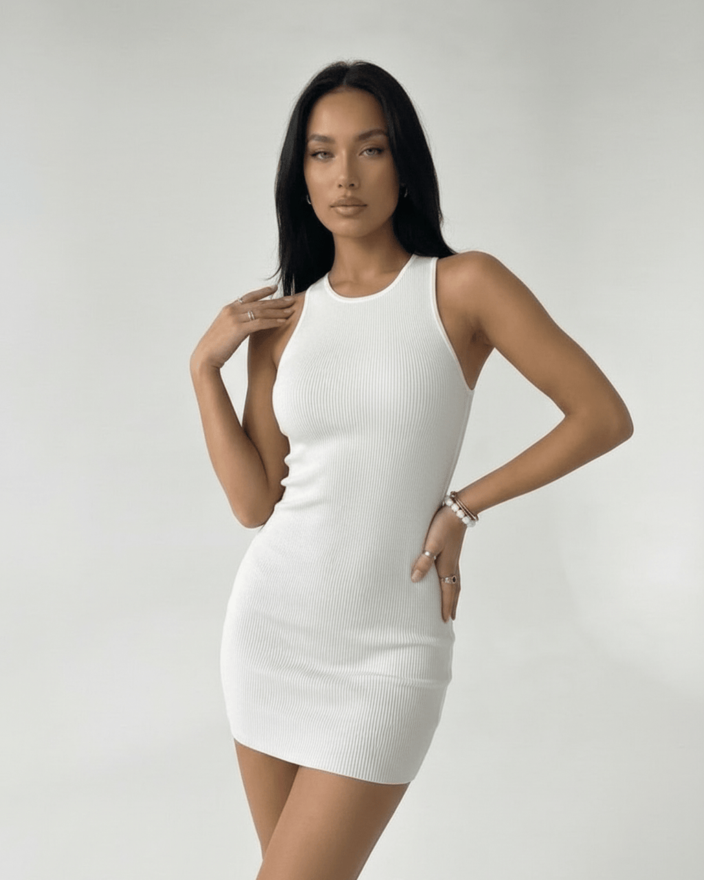 Orion Mini Dress by Lauven – White ribbed knit mini dress with cross back detail and sleek silhouette.