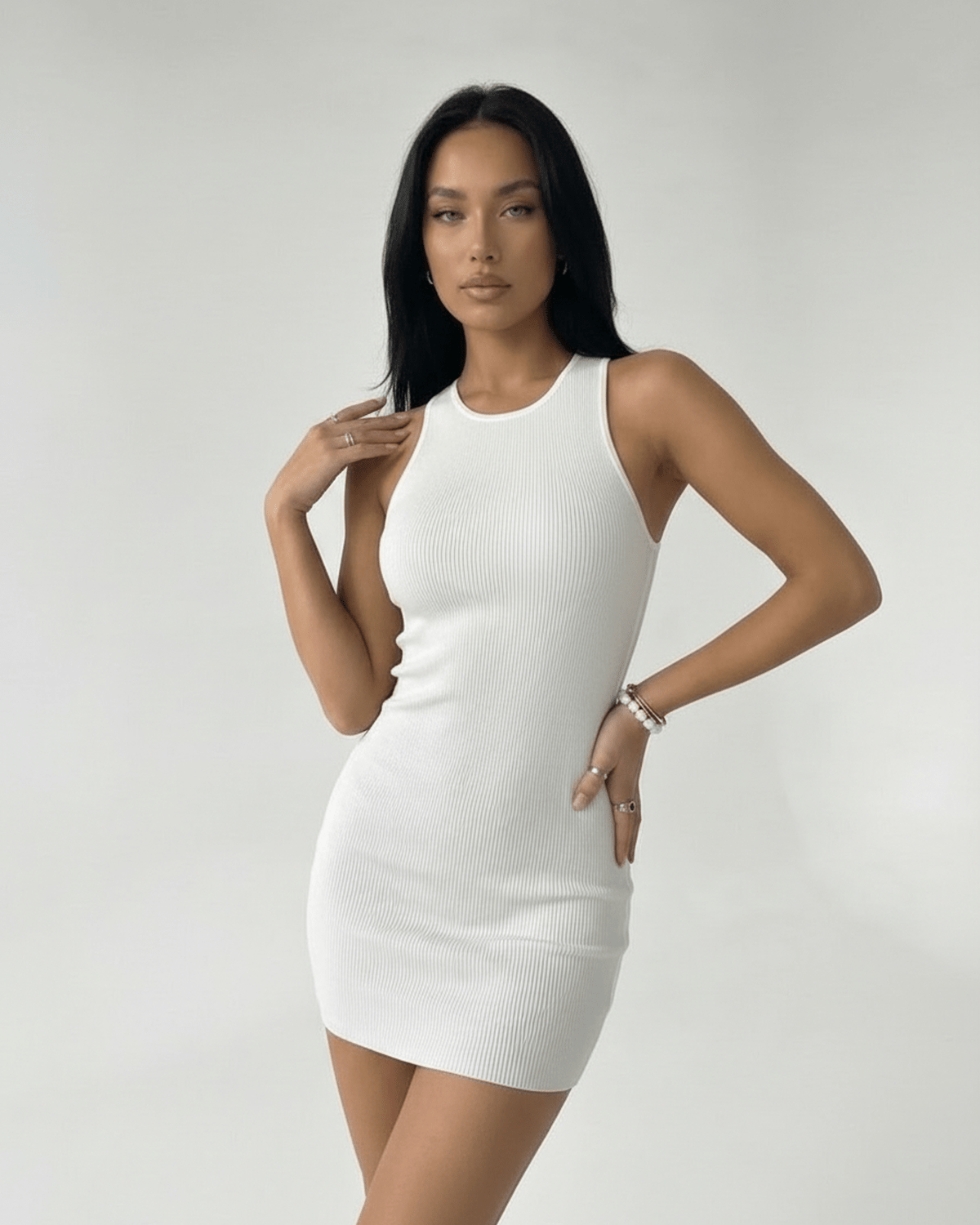 Orion Mini Dress by Lauven – White ribbed knit mini dress with cross back detail and sleek silhouette.