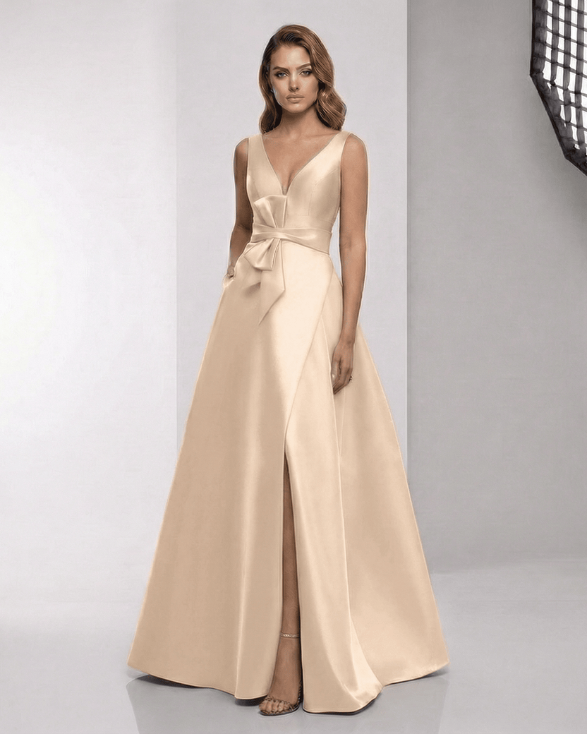Orlena Maxi Dress in champagne satin, featuring a wrap slit, bow waist, and elegant A-line silhouette from Lauven.