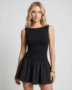Vesper Mini Dress by Lauven — black stretch knit sleeveless bateau neck drop waist pleated mini dress
