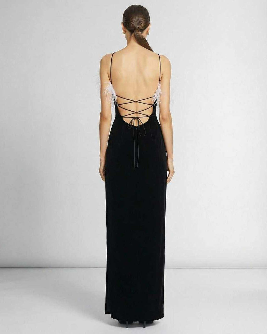 Back view of Celeste Maxi Dress by Lauven featuring feathered halter neckline and sleek black silhouette.