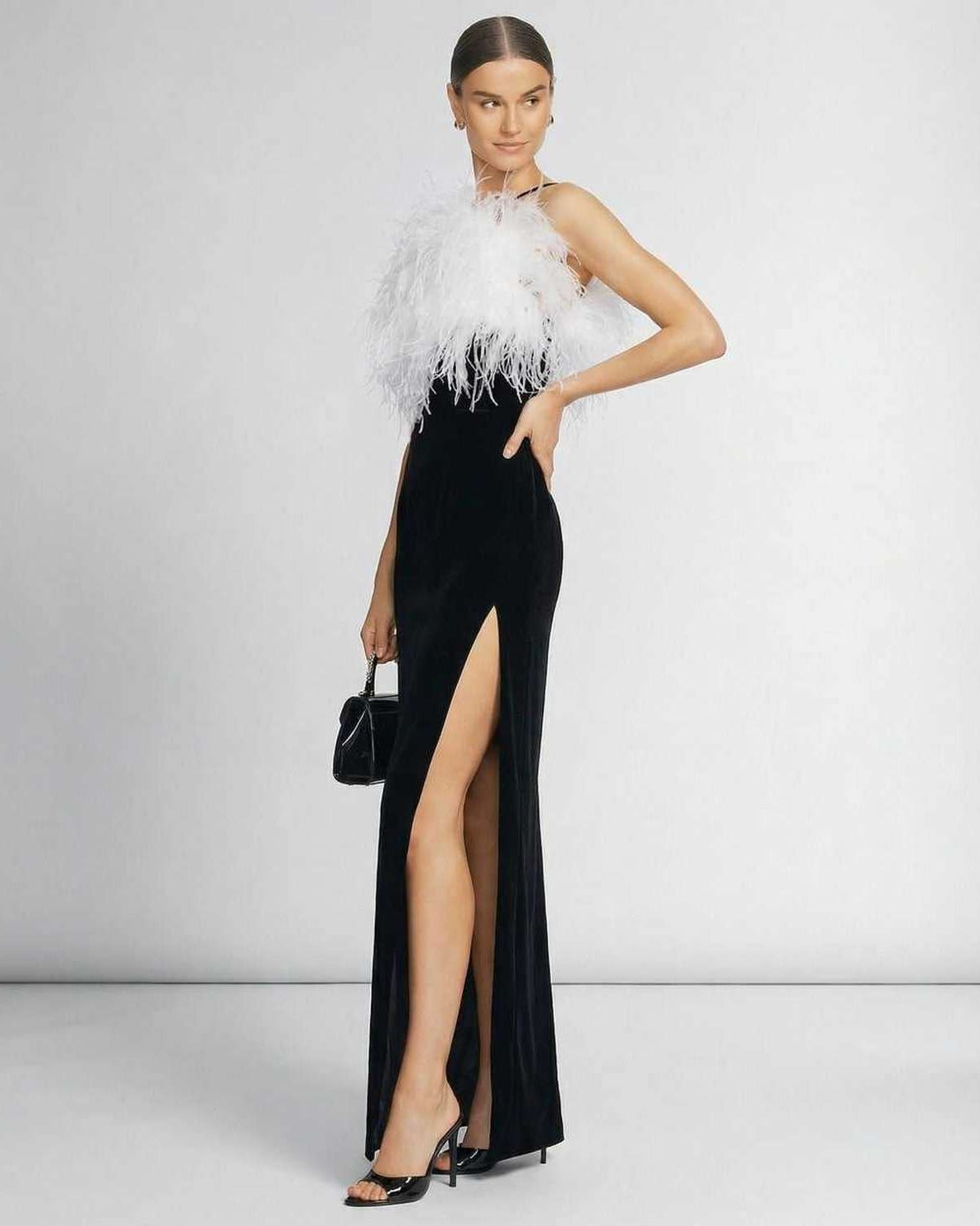 Celeste Maxi Dress by Lauven, featuring a feathered halter neckline and sleek black silhouette.