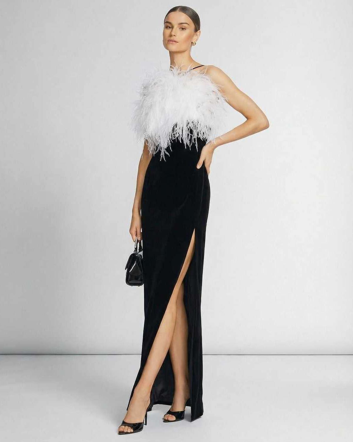 Celeste Maxi Dress by Lauven, featuring a feathered halter neckline and sleek black silhouette.