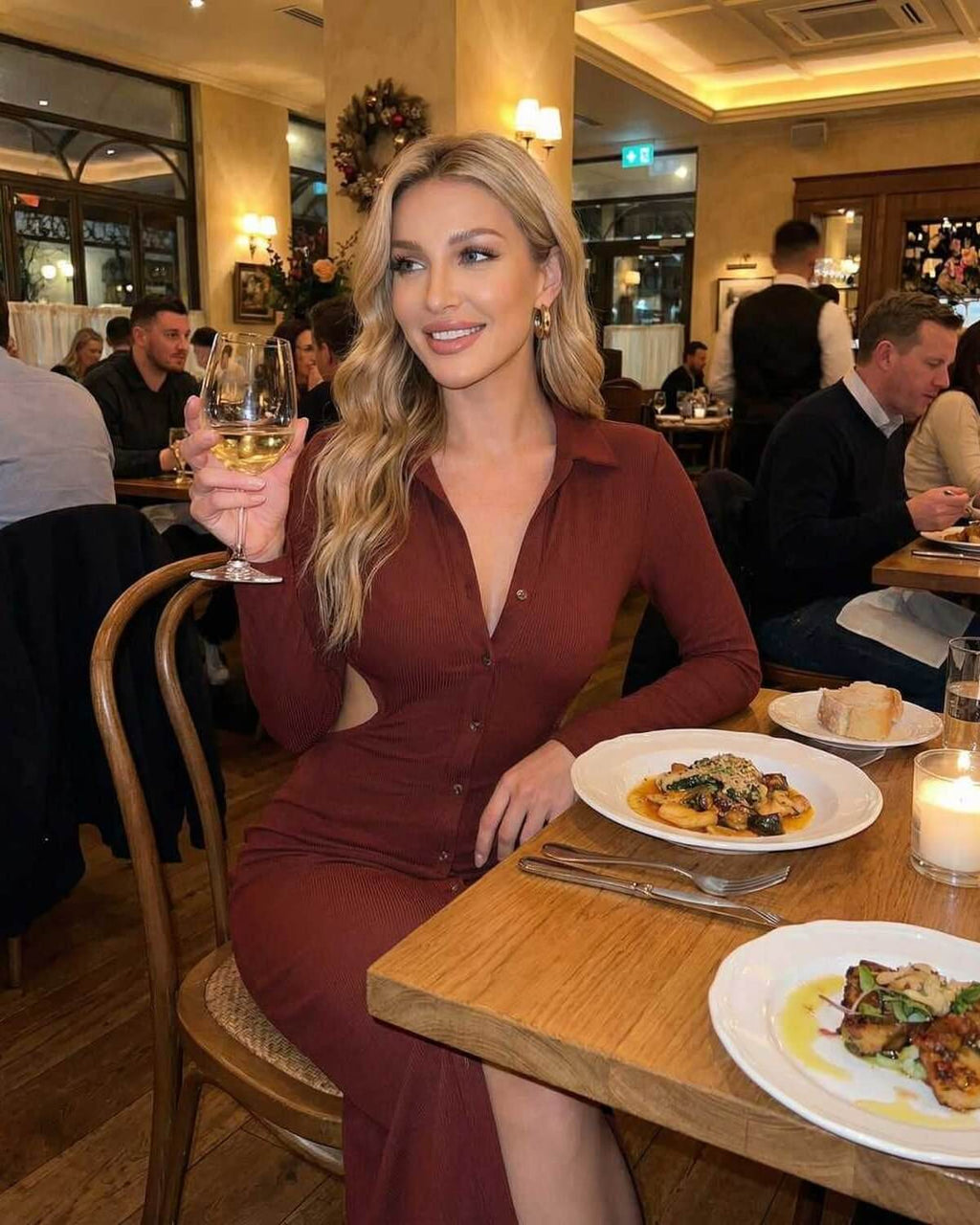 Sienna Midi Dress by Lauven worn by a woman enjoying dinner, showcasing its elegance and style in a cozy restaurant setting.