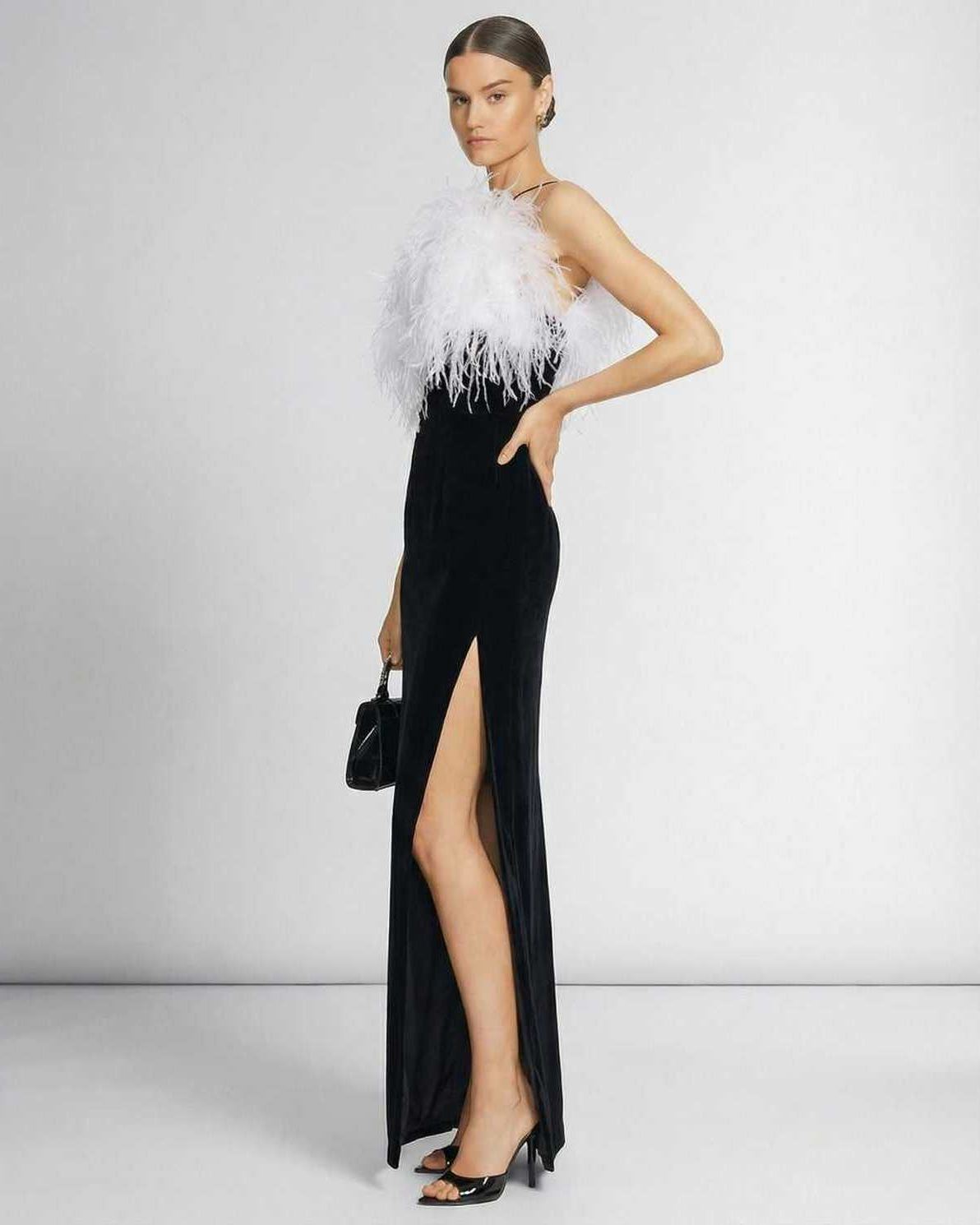 Celeste Maxi Dress by Lauven featuring a feathered halter neckline and a sleek black silhouette with a thigh-high slit.