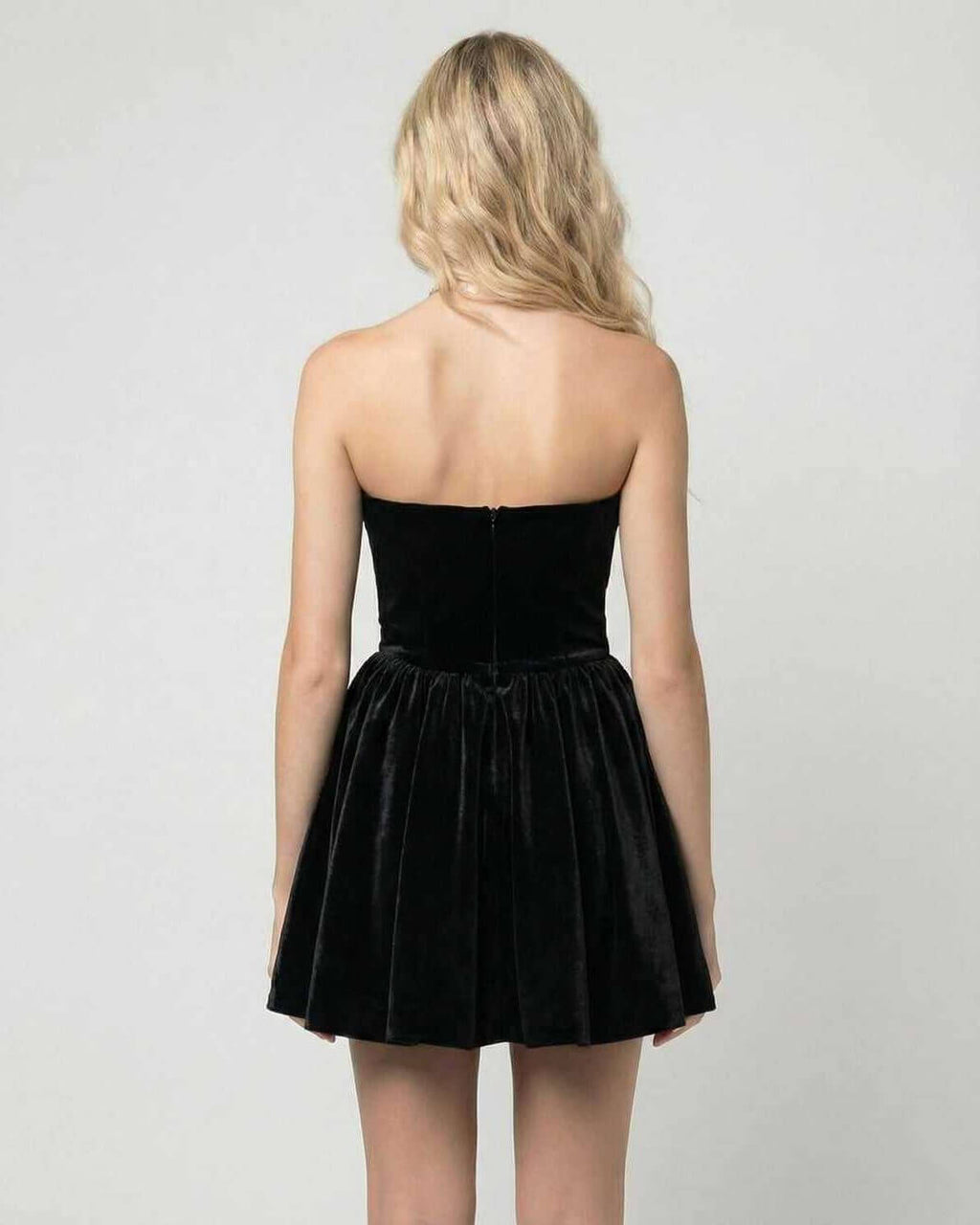 Back view of the Aurora Mini Dress by Lauven, showing a strapless black velvet design with a flared skirt.