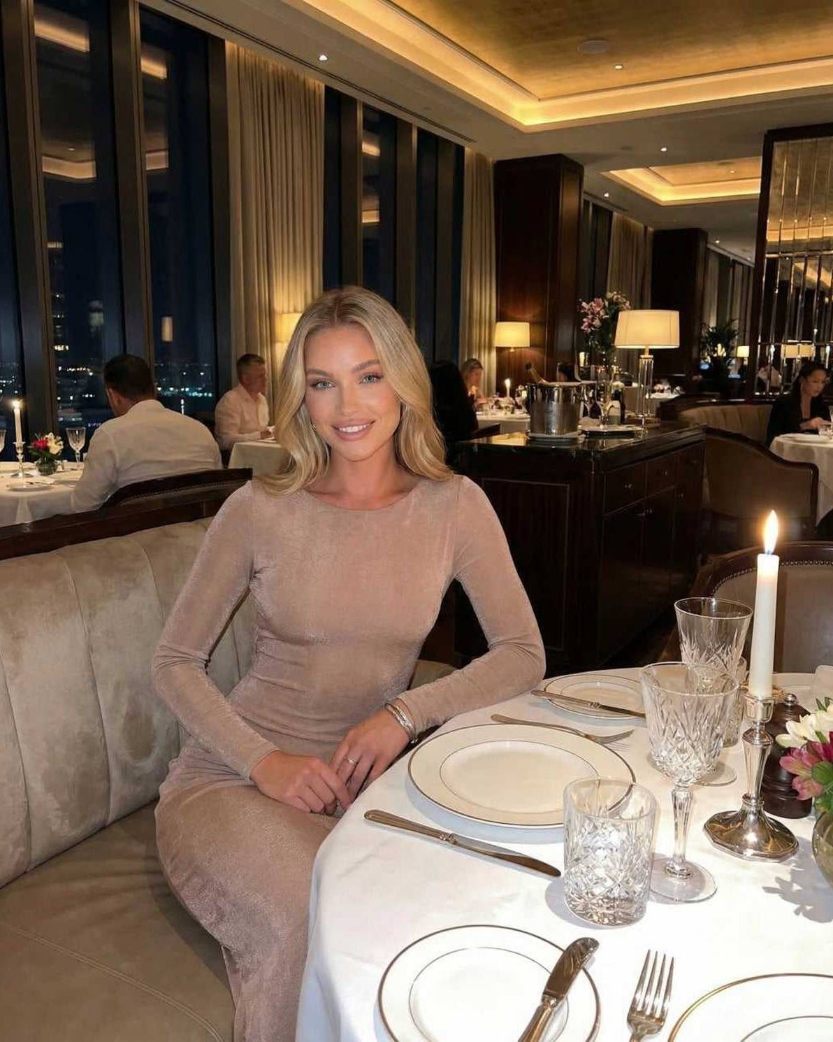 Lauven Selene Maxi Dress worn by a model in a chic restaurant setting, showcasing elegant backless design and refined silhouette.