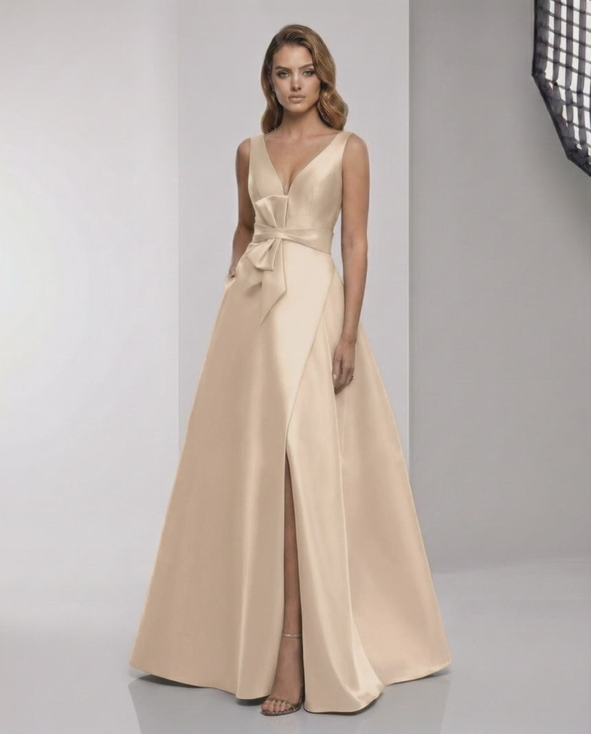 Orlena Maxi Dress - Champagne satin A-line dress with wrap slit, bow waist, and elegant V-neck by Lauven.