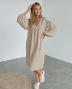 Calista Midi Dress in beige cotton with puff sleeves, embodying modern minimalism and everyday elegance by Lauven.