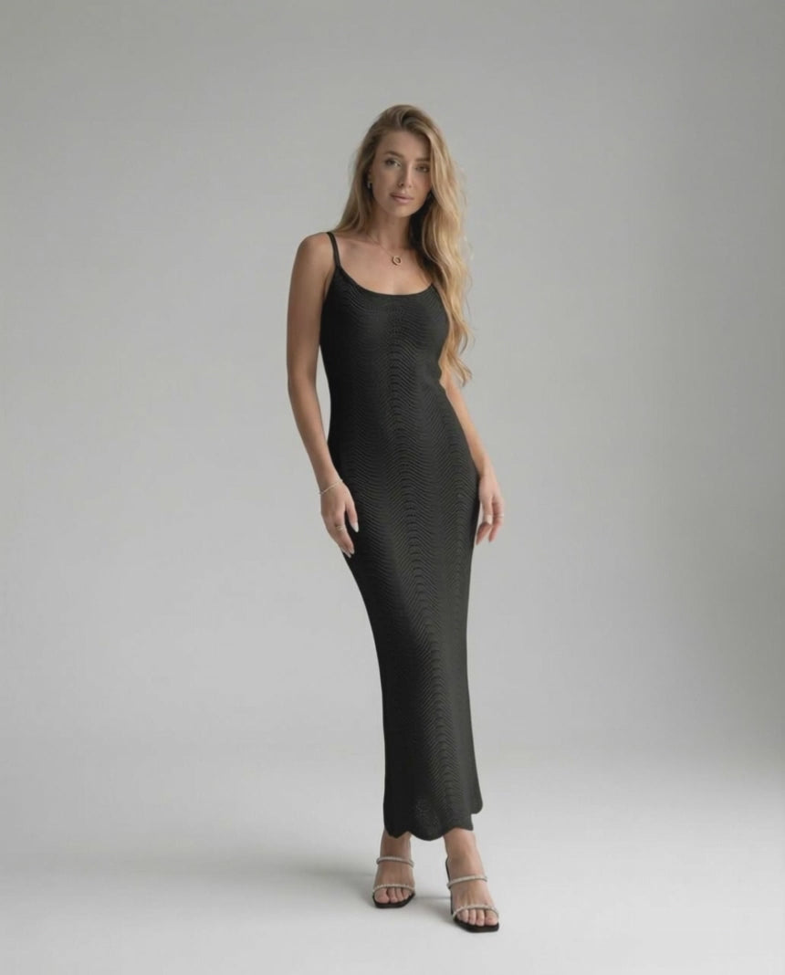 Noiré Midi Dress showcasing a black bodycon design with sleek silhouette, embodying modern sophistication by Lauven.