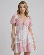 Blossom Mini Dress featuring romantic floral print, tiered ruffles, and A-line silhouette by Lauven.