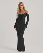 Model wearing Noir Maxi Dress, a black long sleeve bodycon gown with open back halter design by Lauven, showcasing elegant style.