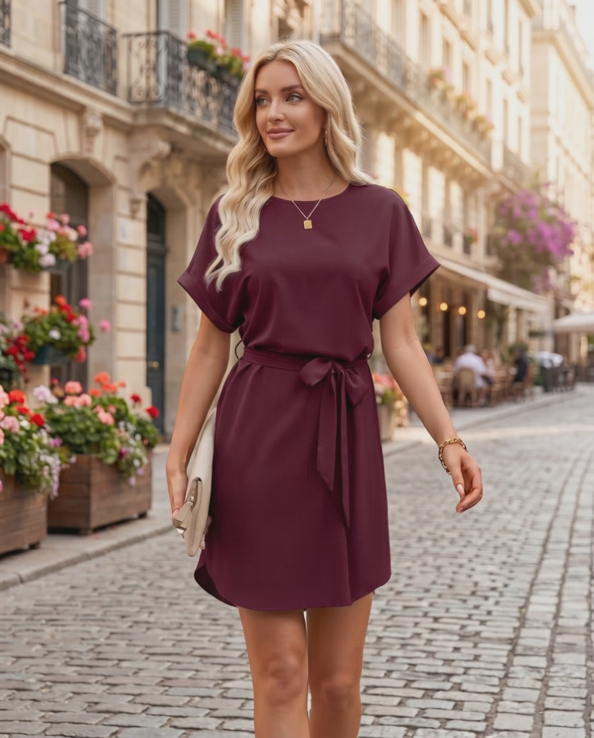 Elara Mini Dress featuring smooth woven fabric, round neckline, relaxed bodice, and self-tie waist by Lauven.