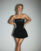 Celeste Mini Dress featuring elegant black strapless velvet fabric and a smooth satin band, exuding modern sophistication by Lauven.