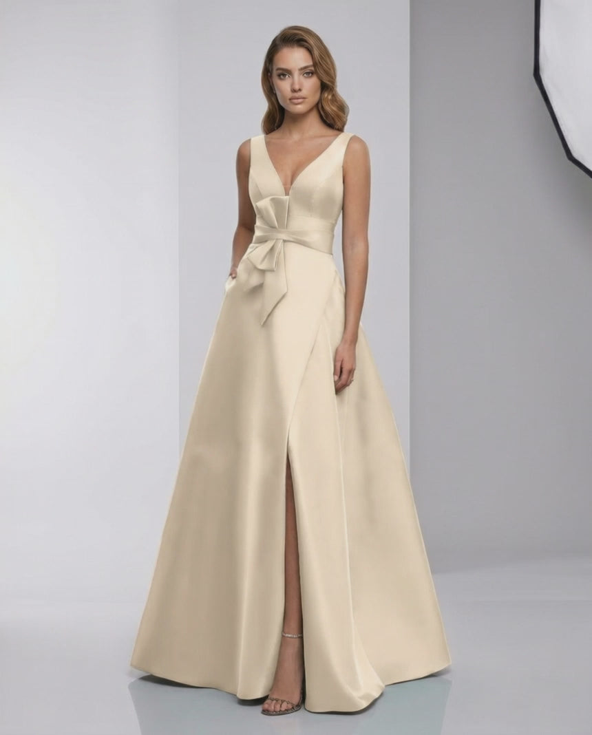 Calista Maxi Dress - elegant satin A-line with bow detail, V-neck, and stylish slit for a refined evening look.