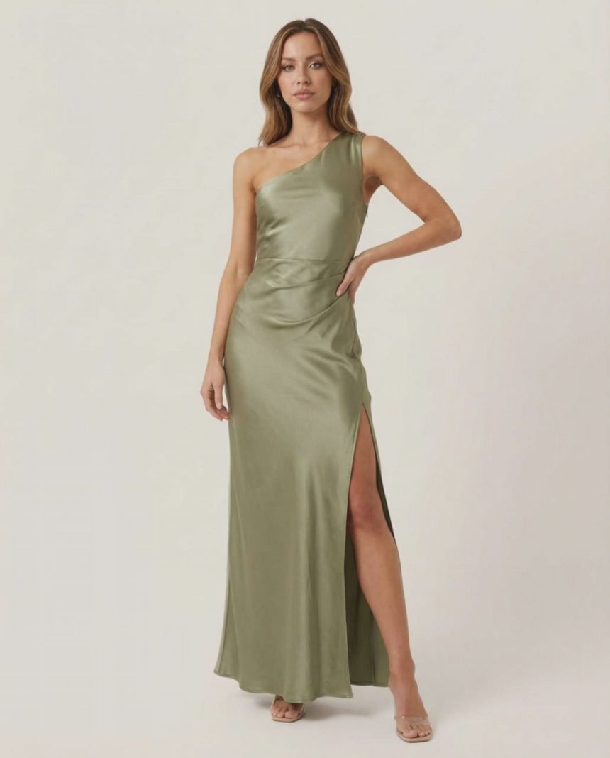 Solene Maxi Dress – One-shoulder satin dress in sage green with side slit, by Lauven, creating an elegant occasion look.