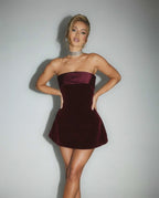 Orion Mini Dress showcasing a luxurious burgundy velvet silhouette, featuring a strapless design by Lauven.