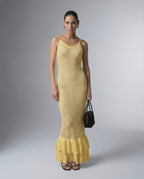 Model wearing Solara Maxi Dress by Lauven, a yellow bodycon maxi dress with hollow out detail.