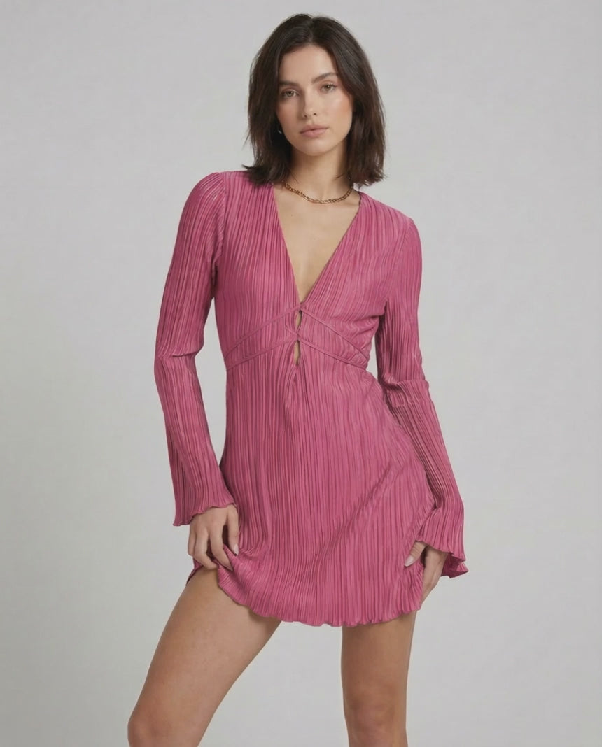 Aurora Mini Dress by Lauven in vibrant pink, featuring pleated fabric, long sleeves, and a deep V-neckline.