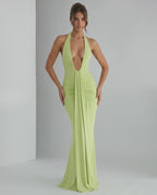 Aurelia Maxi Dress in light green, featuring a halter neck and smooth stretch jersey fabric for a sleek silhouette.