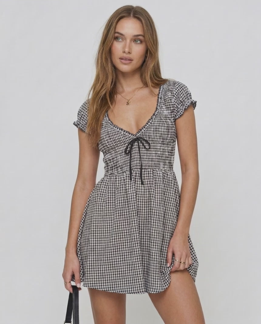 Seren Mini Dress by Lauven, featuring gingham check pattern, V-neck, empire waist, and ruffled cap sleeves.