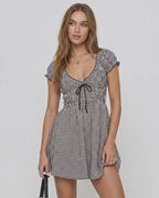 Seren Mini Dress by Lauven, featuring gingham check pattern, V-neck, empire waist, and ruffled cap sleeves.