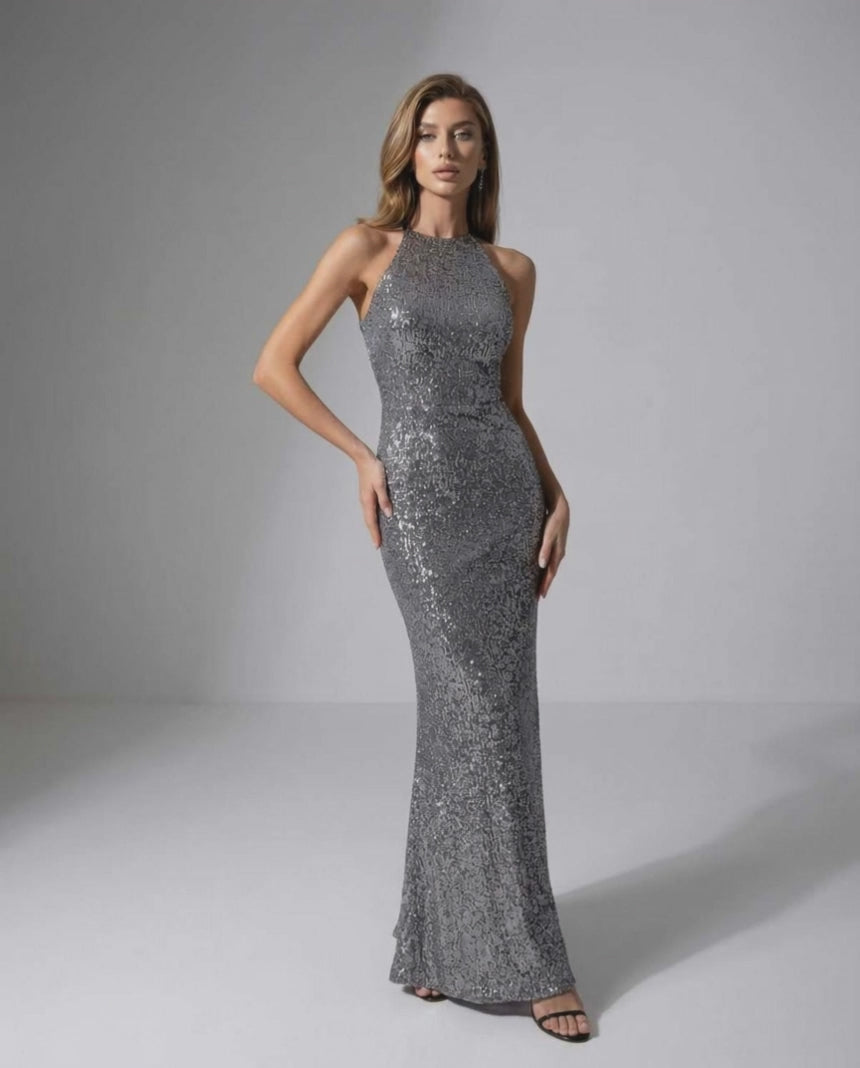 Orion Maxi Dress: Silver sequin dress with halter neck, sleek silhouette, by Lauven for an elegant evening look.