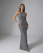 Orion Maxi Dress: Silver sequin dress with halter neck, sleek silhouette, by Lauven for an elegant evening look.