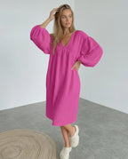 Zafira Midi Dress in vibrant pink, featuring puff sleeves, designed by Lauven for a stylish and comfortable look.