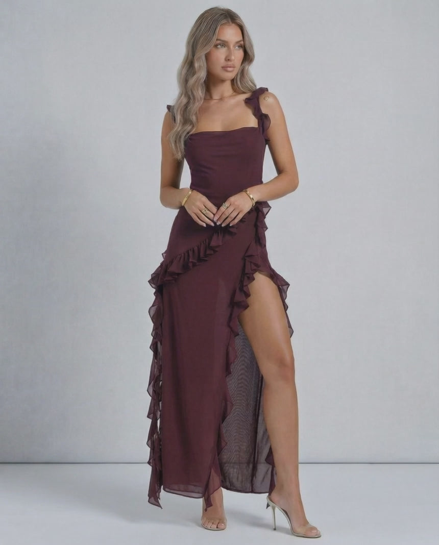 Lauven Amaranth Maxi Dress in deep plum with sheer ruffles and a thigh-high side slit, showcasing elegant style.