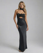Noir Maxi Dress by Lauven, sleek black satin fit and flare evening gown with a strapless neckline and rose detail.