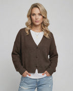 Model wearing a brown Terra Cardigan by Lauven, featuring a relaxed fit and elegant knitwear style.