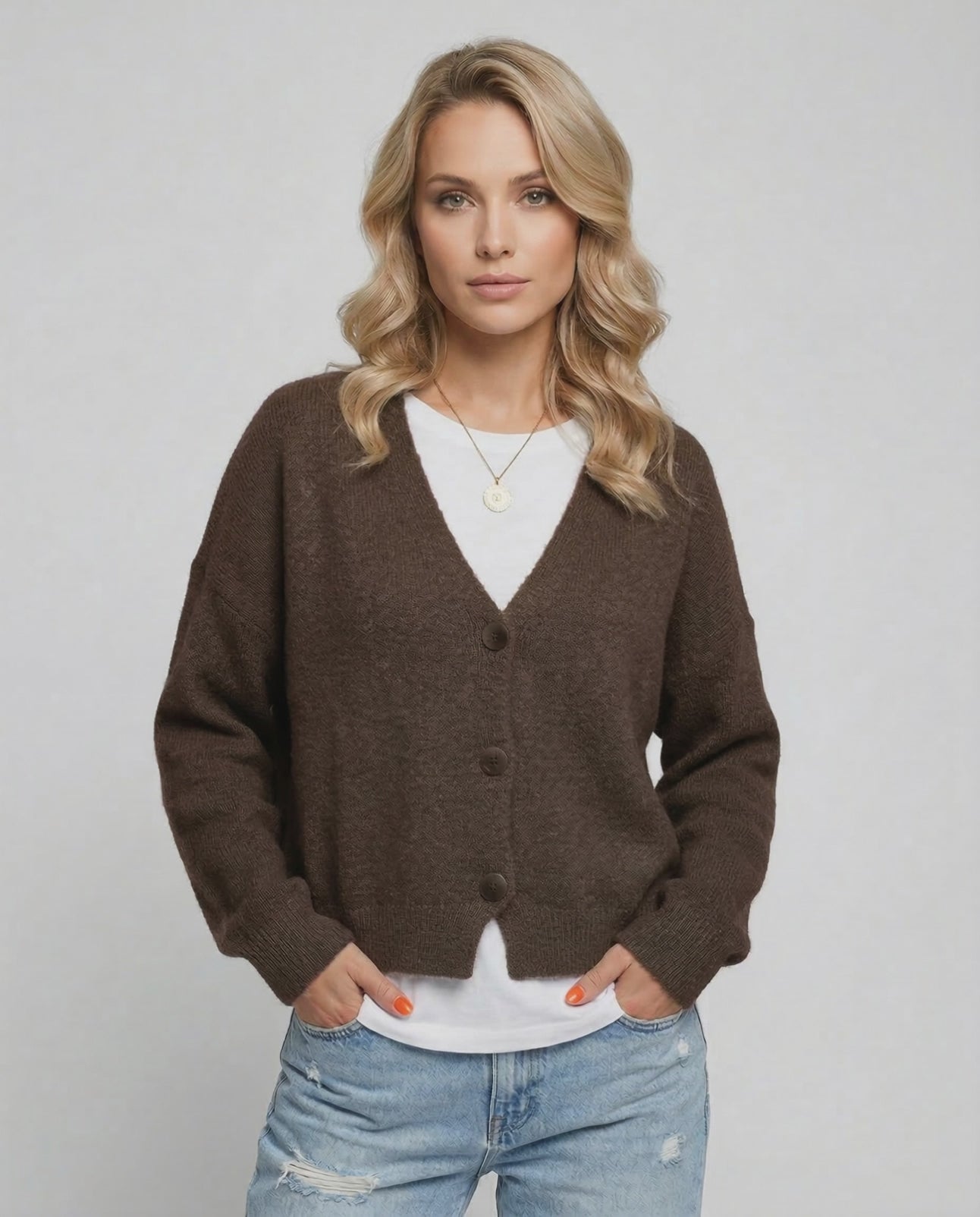 Model wearing a brown Terra Cardigan by Lauven, featuring a relaxed fit and elegant knitwear style.