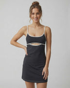 Model wearing the Celeste Mini Dress by Lauven, featuring a sleek cut-out detail and contrasting white trim accents.