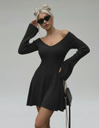 Model wearing Lauven Noir Mini Dress with V-neck and flared sleeves in black knit.