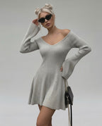 Model wearing Lauven Luna Mini Dress, light gray knit with V-neck and flared sleeves, perfect for stylish occasions.