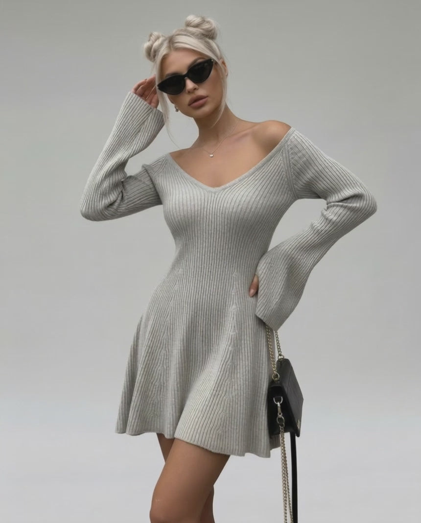 Model wearing Lauven Luna Mini Dress, light gray knit with V-neck and flared sleeves, perfect for stylish occasions.