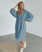 Aurelia Midi Dress in blue cotton, featuring puff sleeves and a flattering v neck, offering comfort and elegance by Lauven.