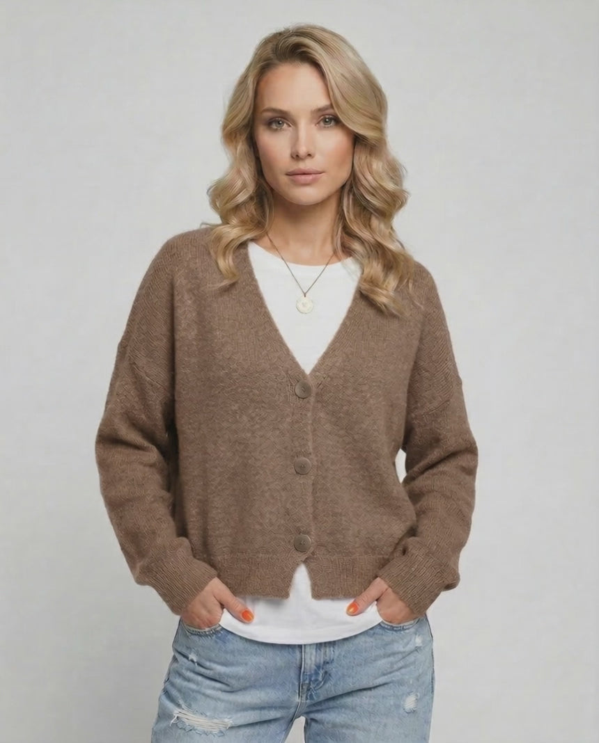 Model wearing the Celeste Cardigan, a soft brown knitwear piece by Lauven for modern elegance.