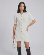 Model wearing the Elysia Mini Dress by Lauven, featuring a casual knit design and single-breasted button closure.