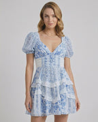 Azure Mini Dress by Lauven, features blue floral print, tiered ruffles, and flattering A-line silhouette.