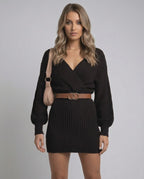 Model wearing Solara Mini Dress by Lauven, a chic black high waist bodycon knit dress with deep V-neckline.