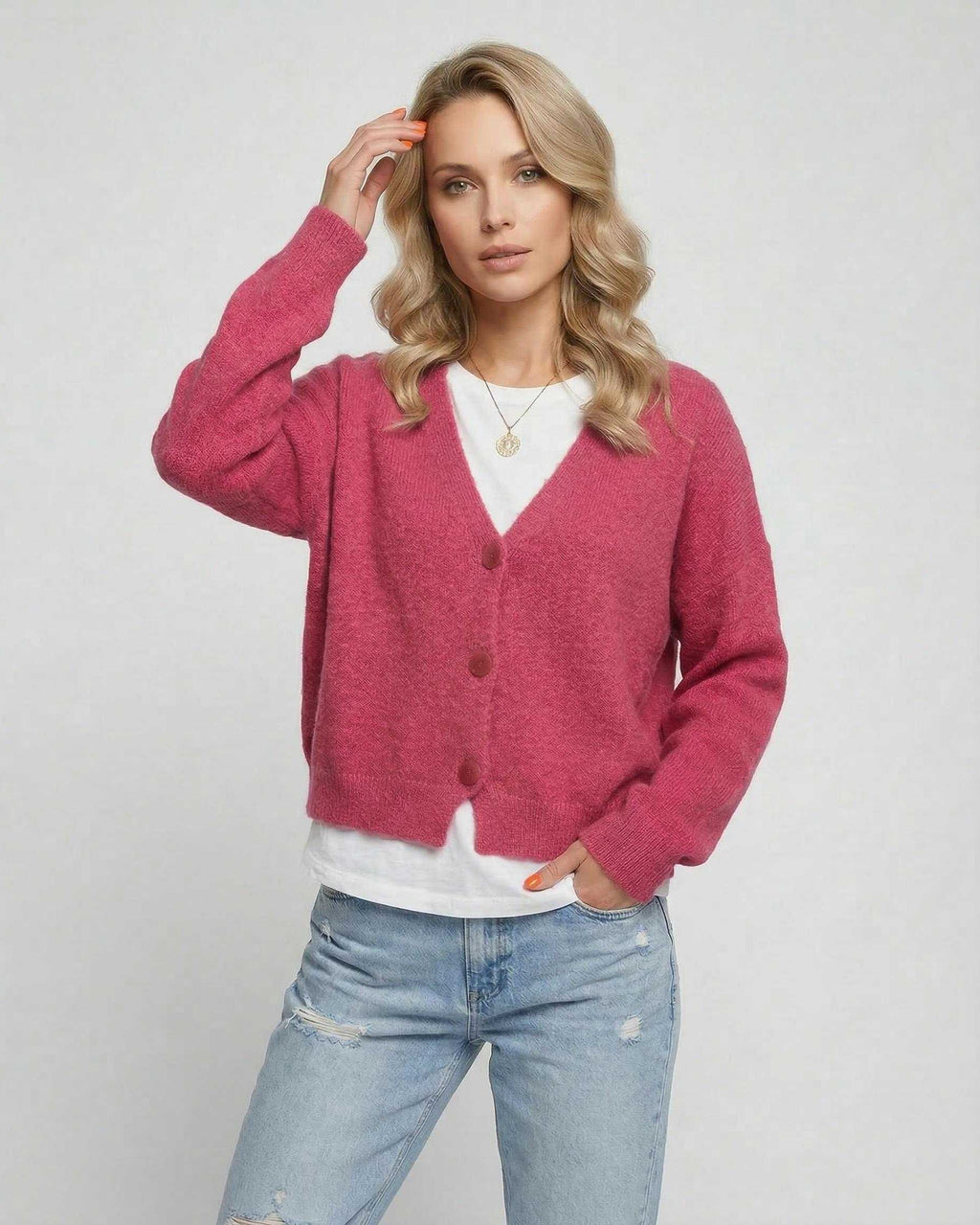 Model wearing the Rosea Cardigan by Lauven in vibrant pink, showcasing a relaxed fit and soft knit fabric.