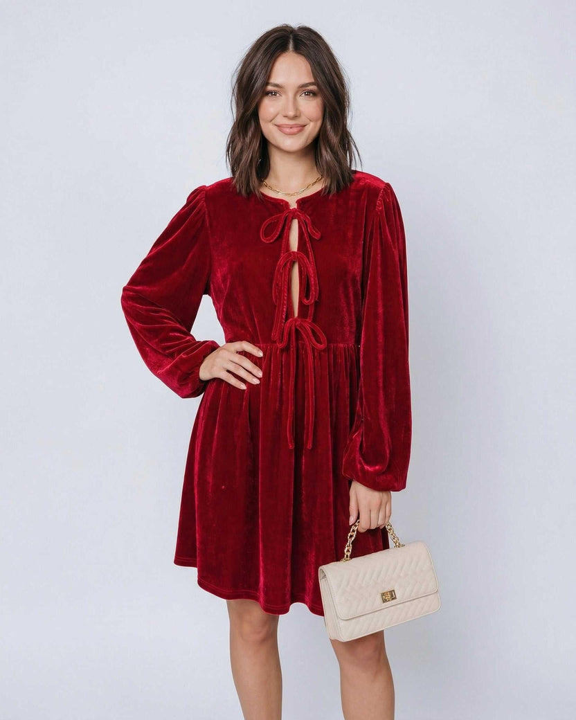 Ruby Mini Dress by Lauven, featuring a red velvet fabric with lantern sleeves and a drawstring detail.