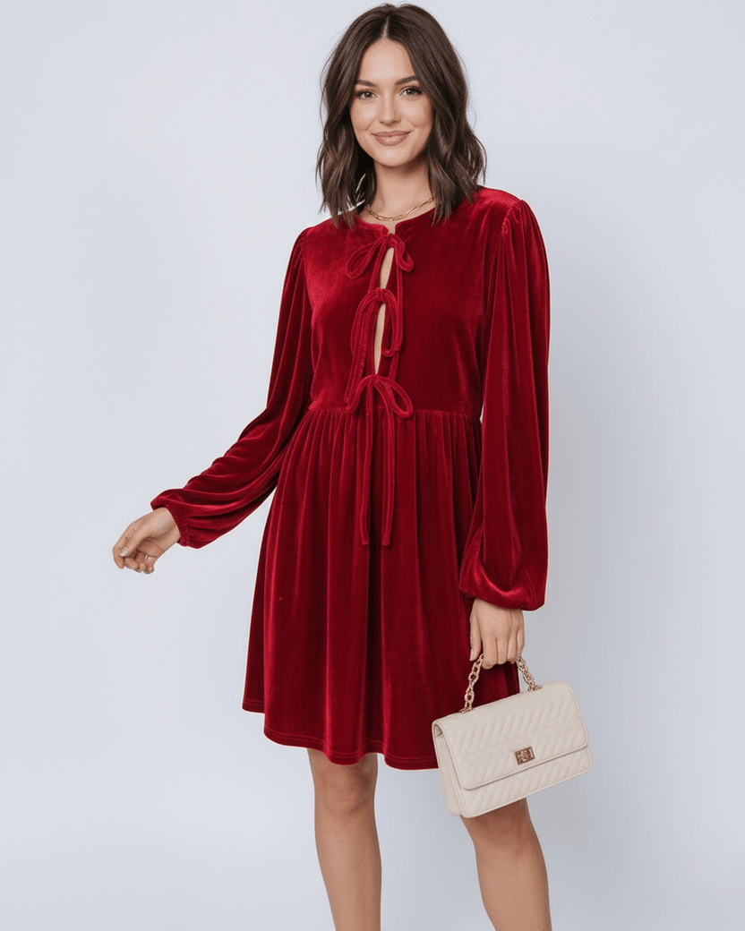 Ruby Mini Dress by Lauven features a luxurious red velvet fabric, flowing skirt, and elegant lantern sleeves.